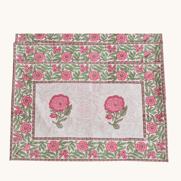Floral patterned placemats with pink flowers on a white background