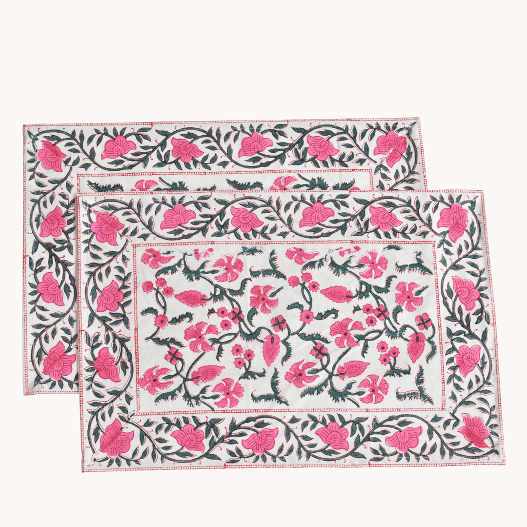 Two floral placemats with pink flowers on a white background