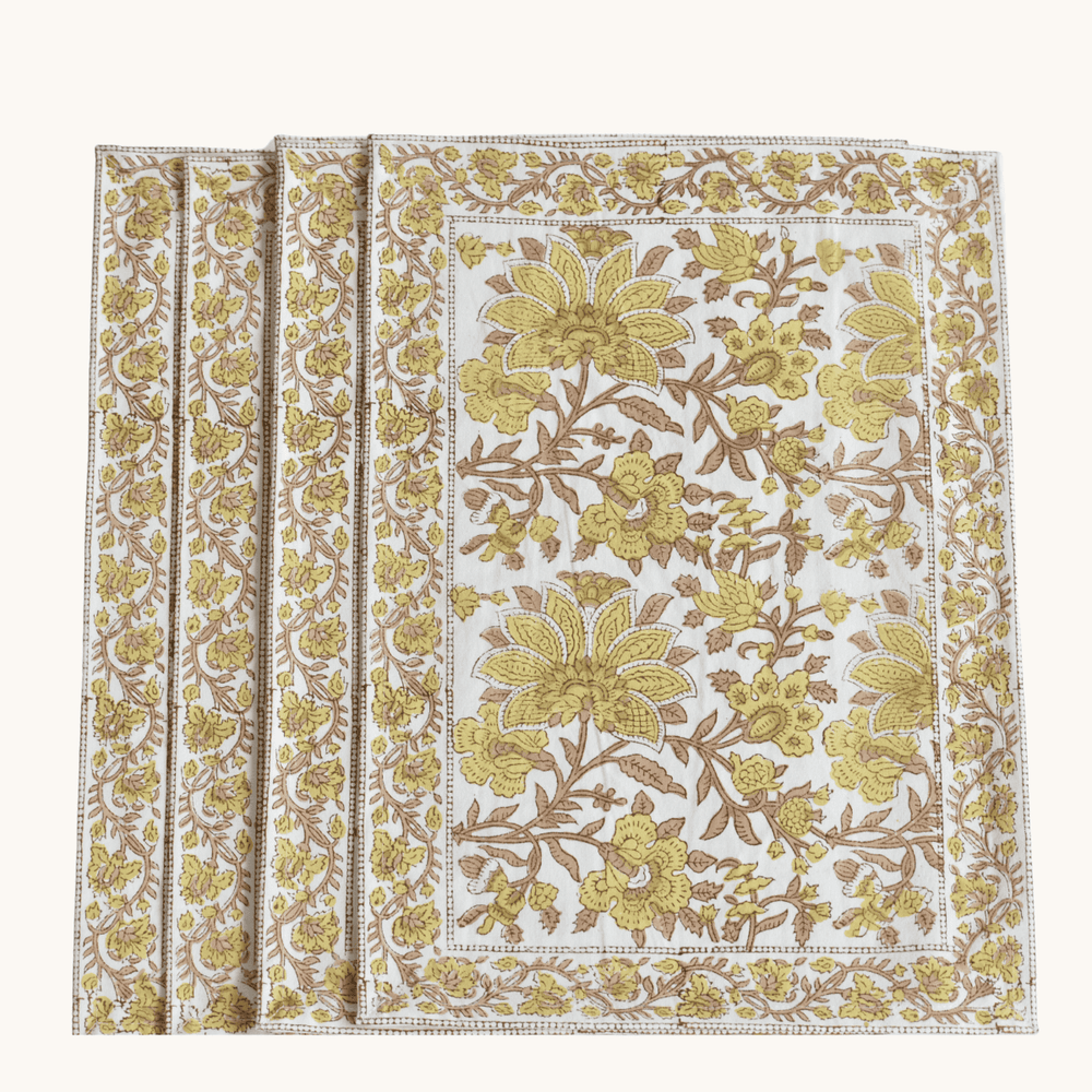Floral patterned placemats with yellow and brown colors on a white background