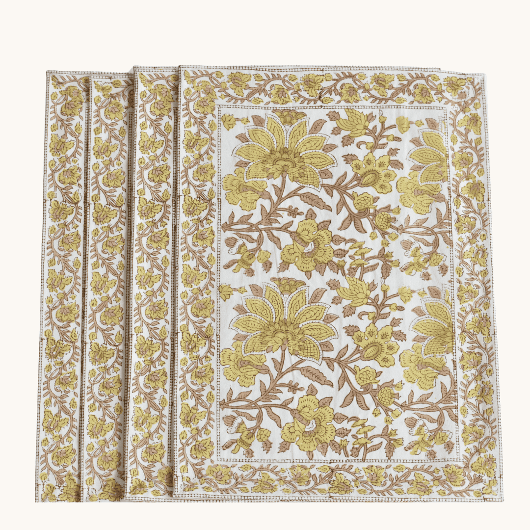 Floral patterned placemats with yellow and brown colors on a white background