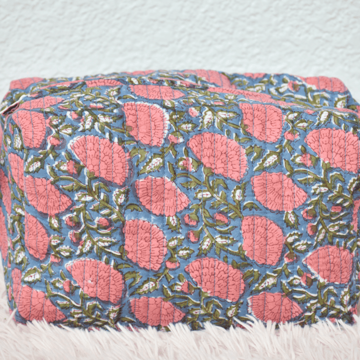 Floral patterned ottoman on a light blue background