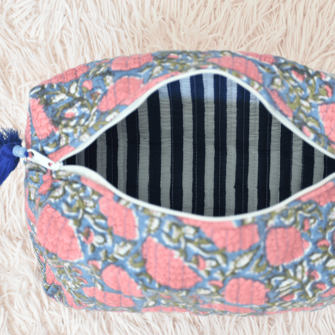 Decorative pouch with floral pattern on a fluffy white surface