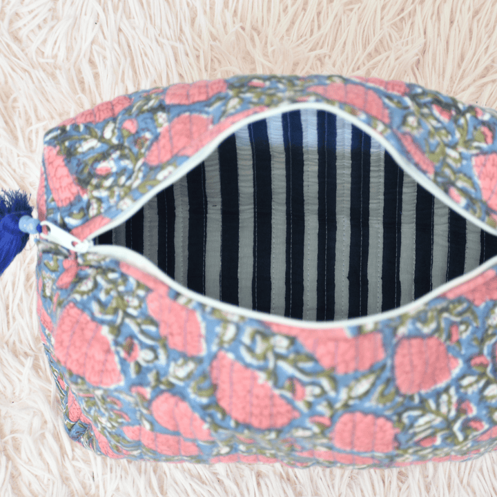 Decorative pouch with floral pattern on a fluffy white surface