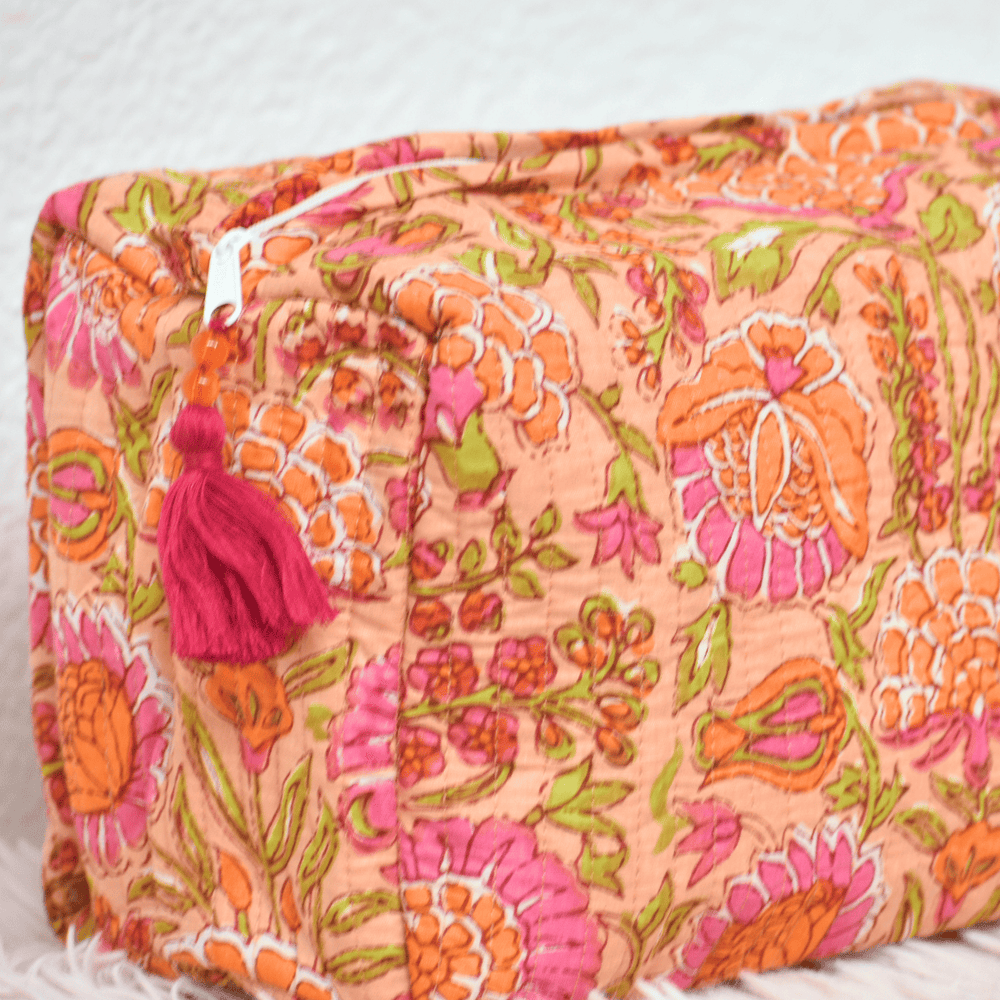 Floral patterned pouch with tassel on a light background