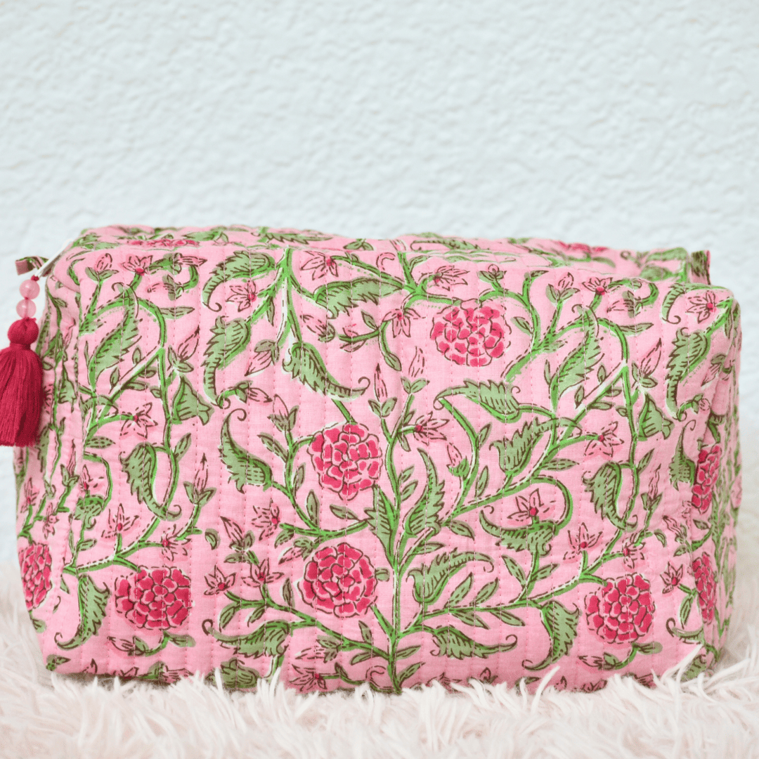 Pink pouch with green floral pattern on a white background