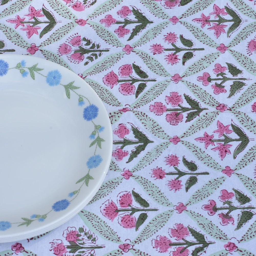 Floral-patterned tablecloth with a decorative plate on a matching fabric background