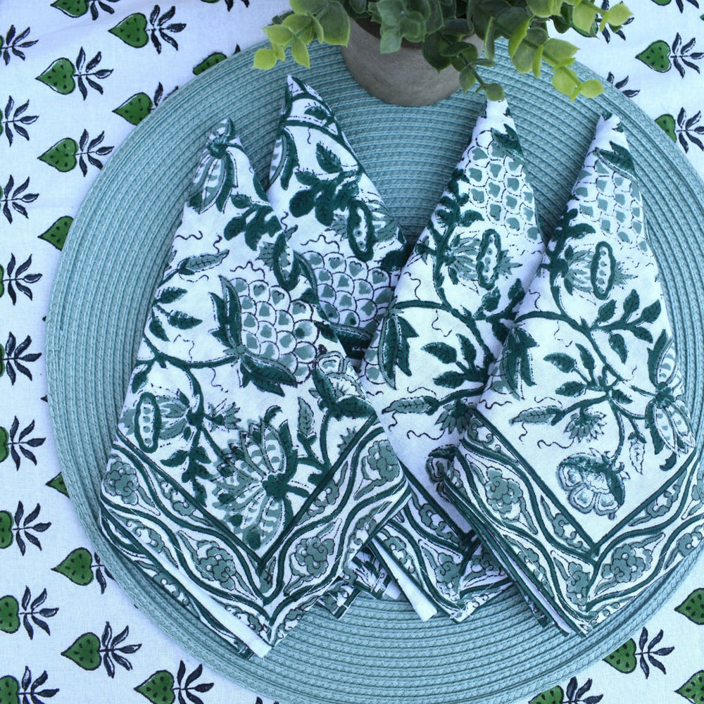 Cedar Trail - Cotton Table Napkin Set styled on a woven teal placemat over matching tablecloth.