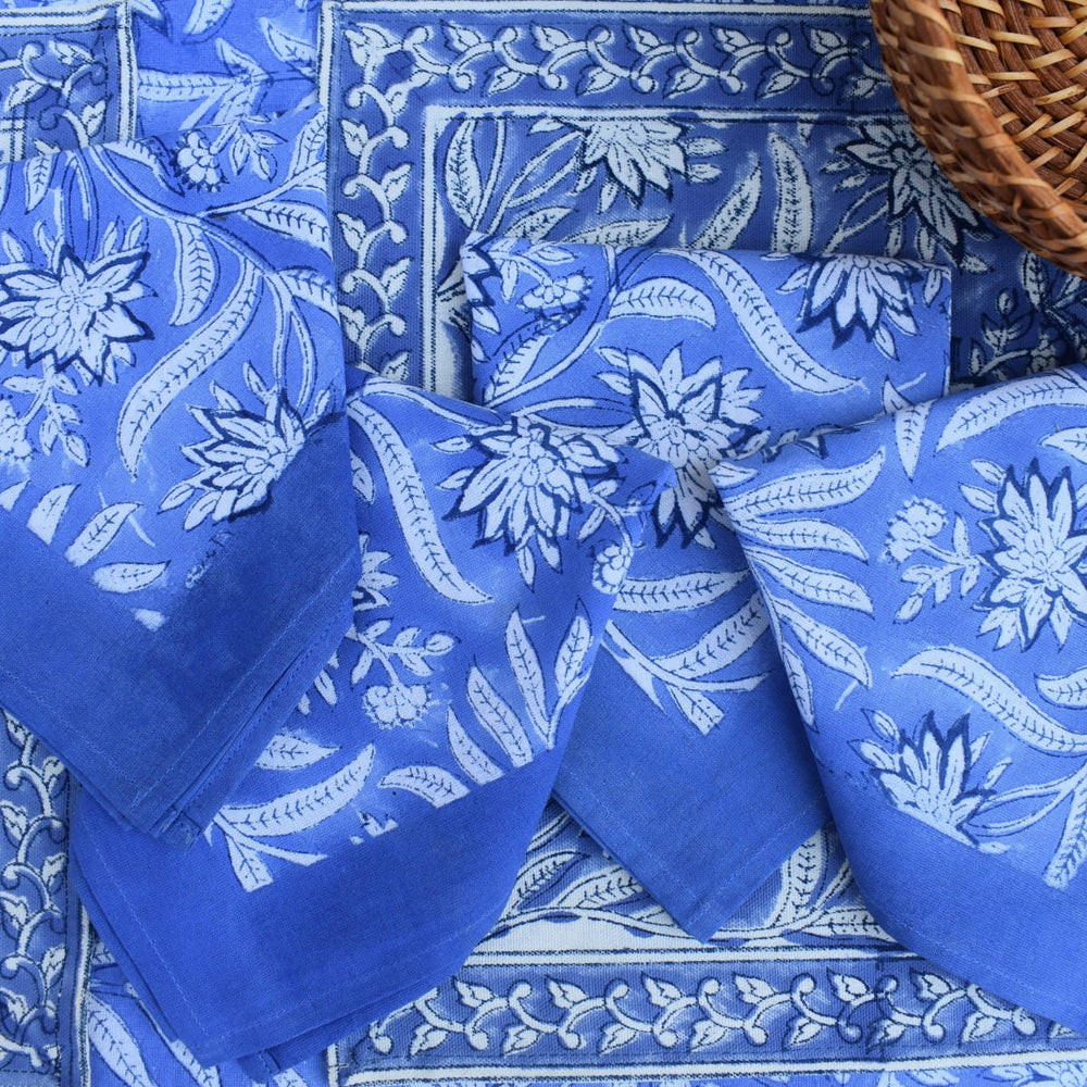 Indigo Tide cotton napkins styled on a matching tablecloth with a basket.